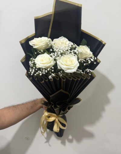 Midnight Luxury White Roses bouquet featuring fresh white roses and baby breath in black wrapping with gold borders from J's Store