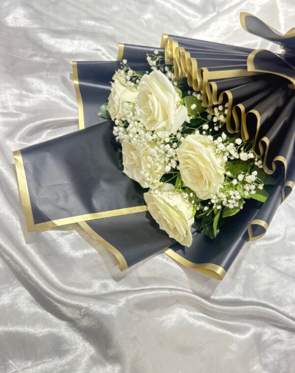 Midnight Luxury White Roses flat lay featuring pristine white roses in black and gold paper on a satin background from J's Store
