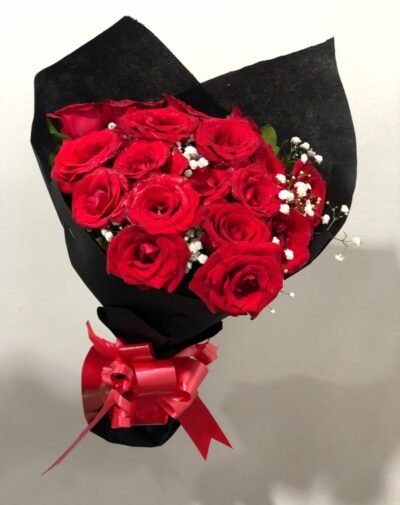 Passion’s Edge Fresh Roses bouquet featuring red roses and baby's breath in black wrapping paper from J's Store