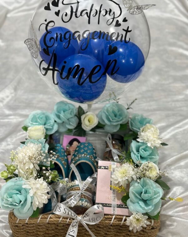 The Royal Festive Trousseau Basket Close-up showing matching khussa bangles Hooked perfume and customized engagement balloon in handmade jute basket from J's Store